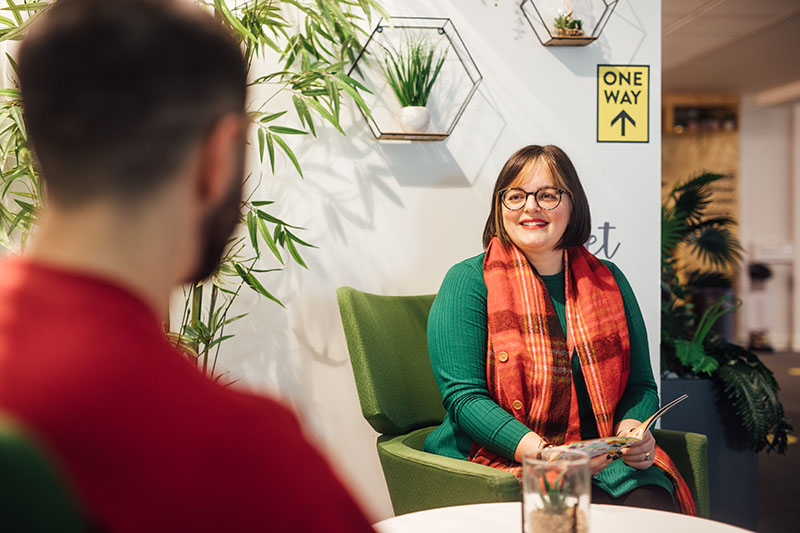 Staff member smiling at a student providing a guidance appointment