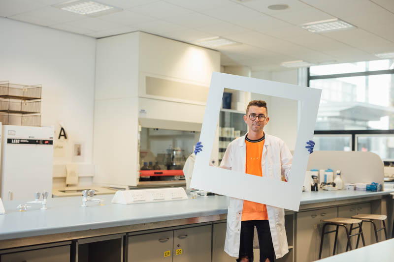 Image of student in Pharmacy holding large polaroid frame 