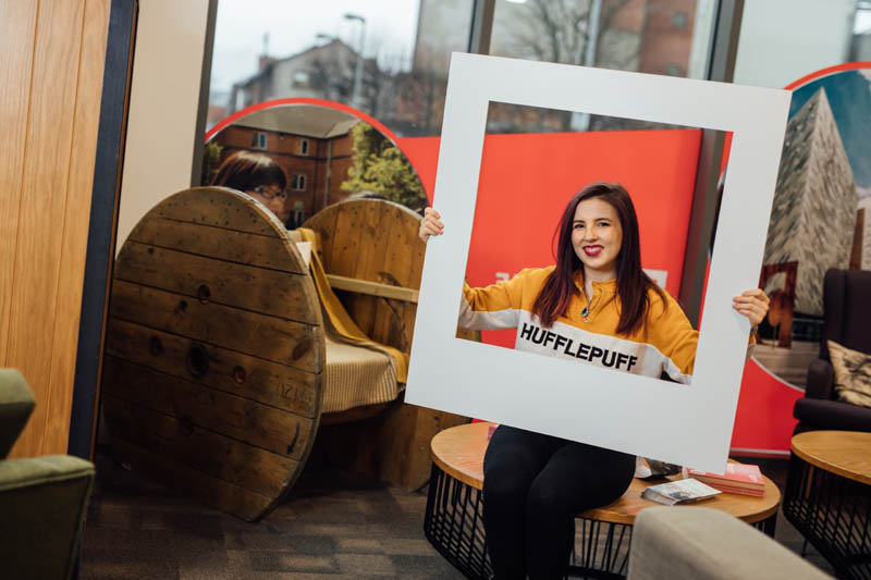 Image of student with large polaroid frame