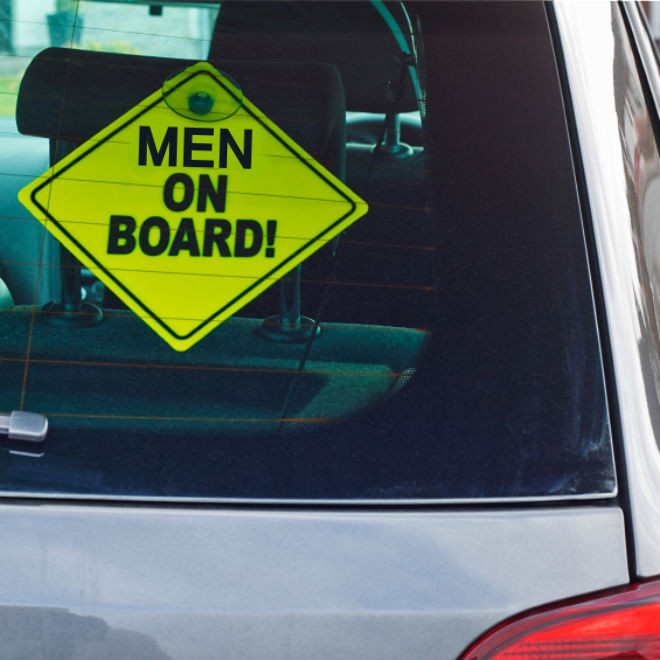 Car with sign in window reading 