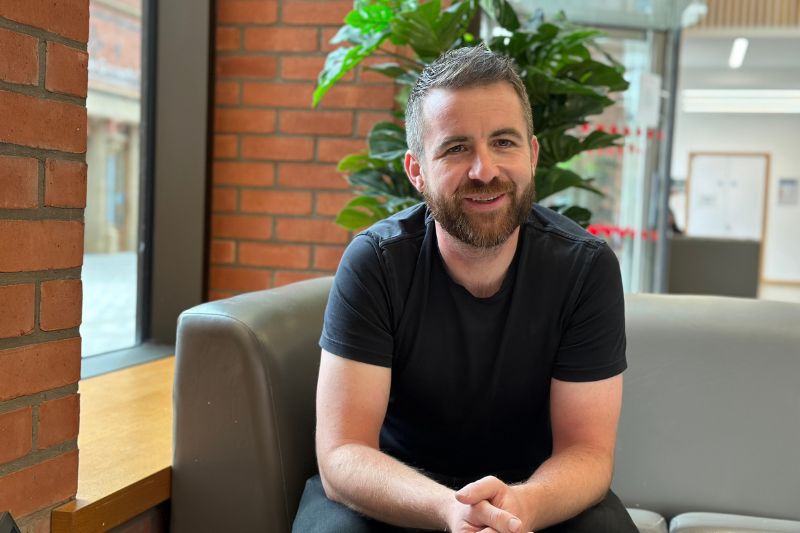 Ben Healey, Queen's University Belfast, seated and chatting to someone off-camera