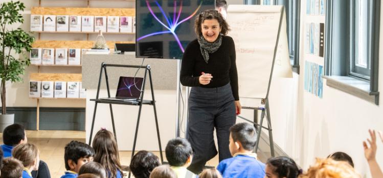 artist Ingrid Hess speaking to school pupils at the Reach '24 arts and sustainability festival's exhibition or her works in the Naughton Gallery